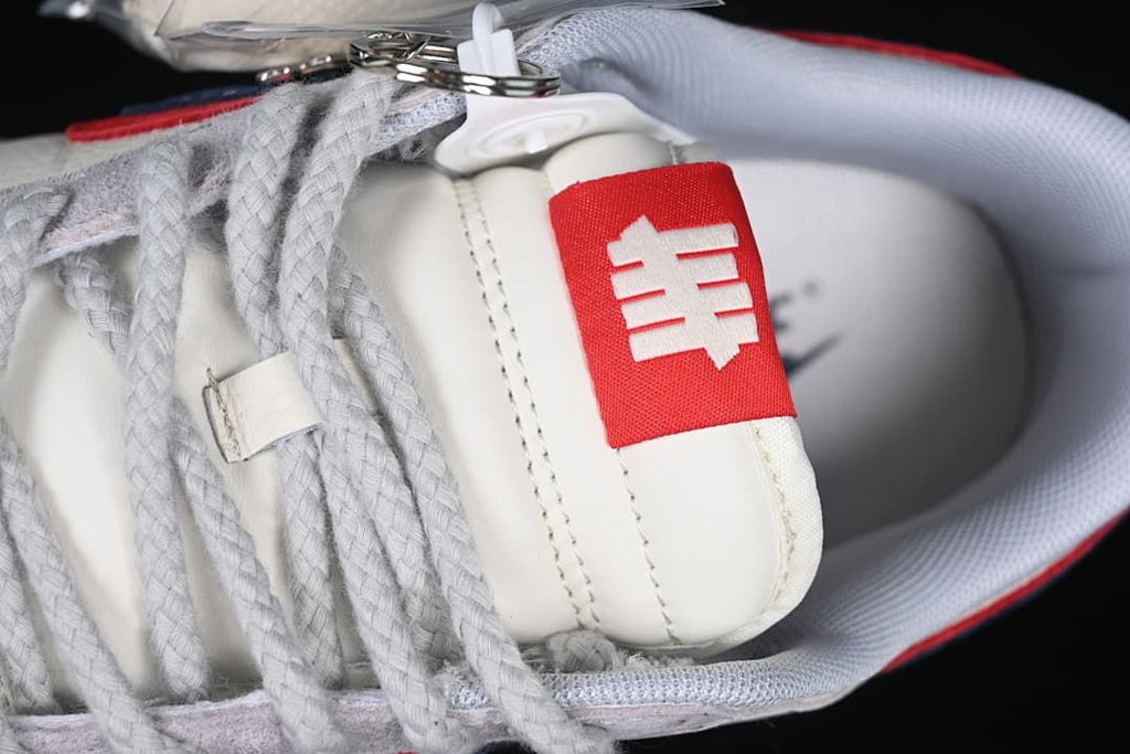 Close-up of the tongue tag, laces and attached accessories.
