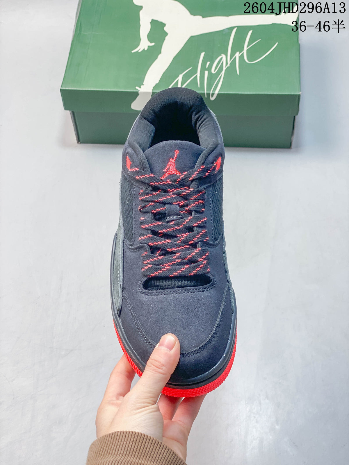 Front view of a navy sneaker with contrast laces, mesh panels, and red accents.
