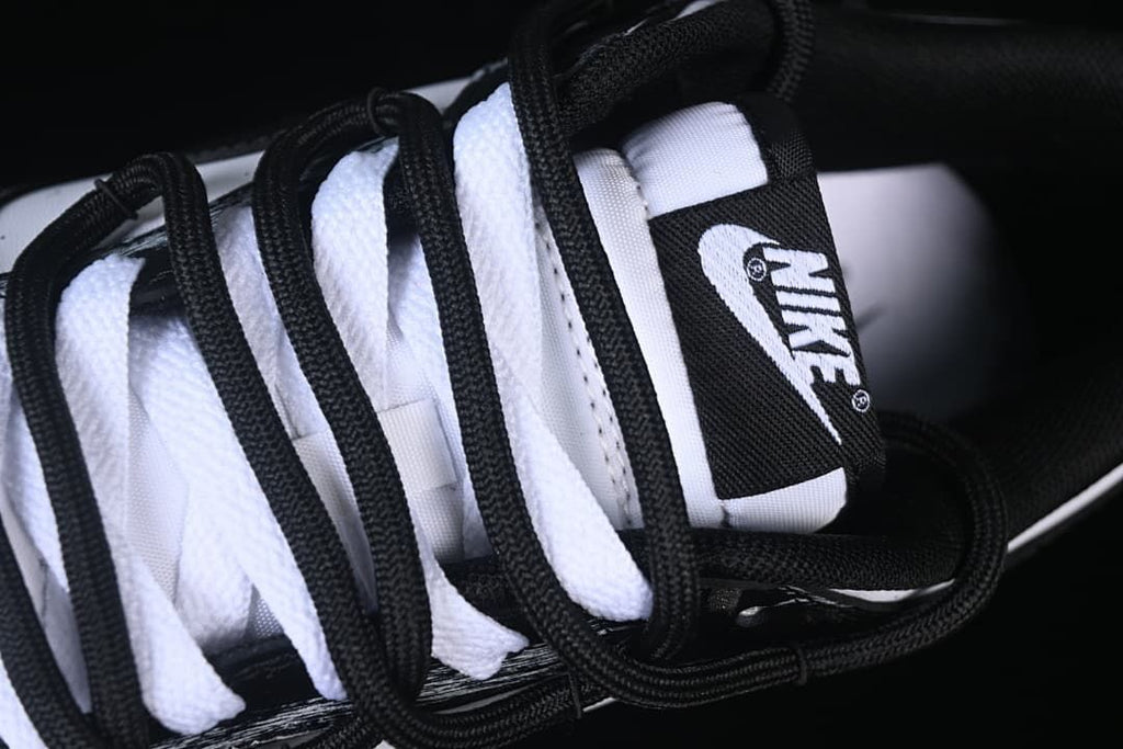 Close-up of the tongue and layered black and white laces