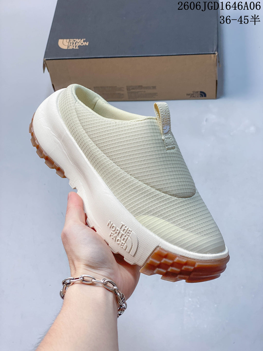 Side view of the cream mule with The North Face branding