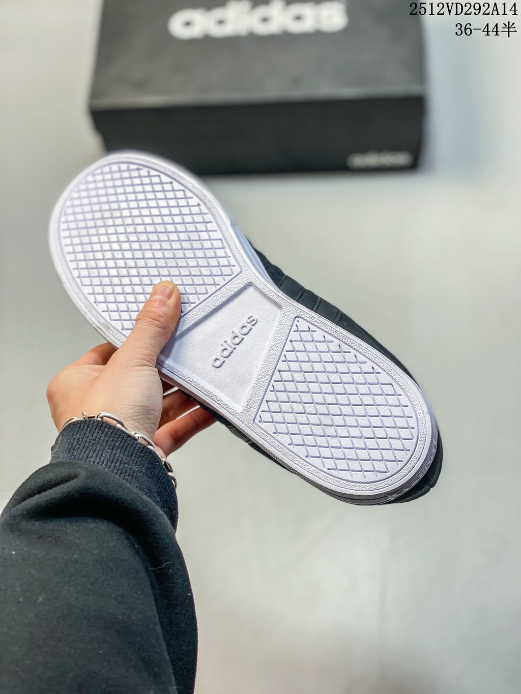 Underside of a dark Adidas high-top sneaker showing the patterned white sole.