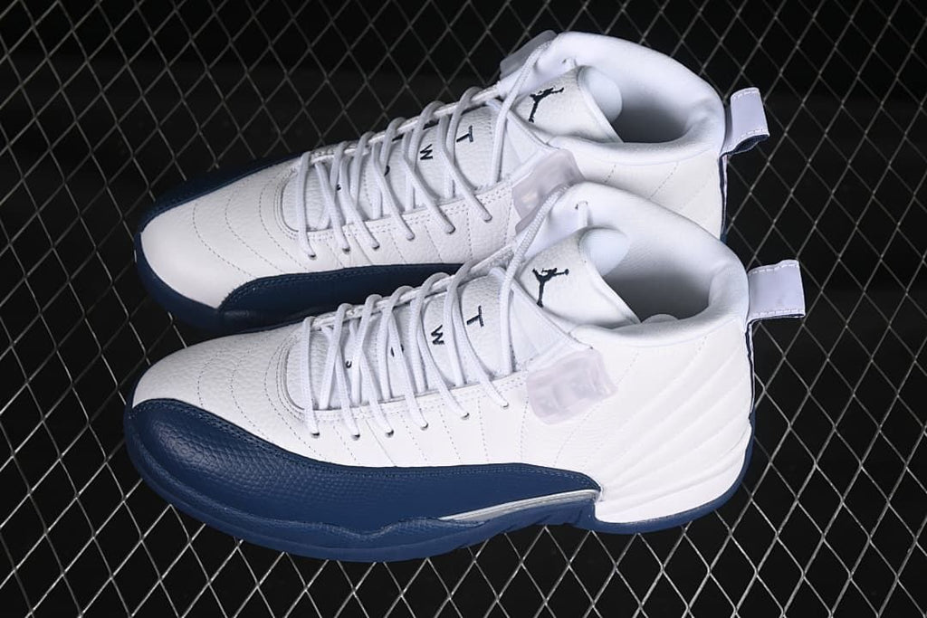 Pair of white and navy Air Jordan 12 Retro sneakers viewed from above