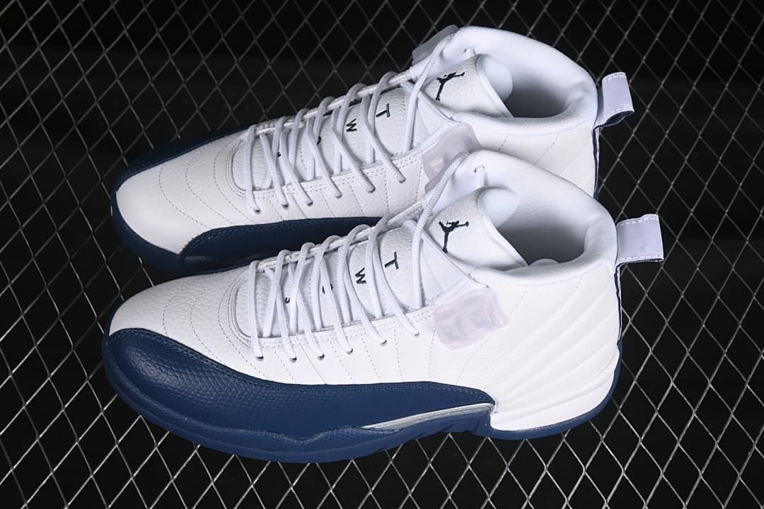 Pair of white and navy Air Jordan 12 Retro sneakers viewed from above