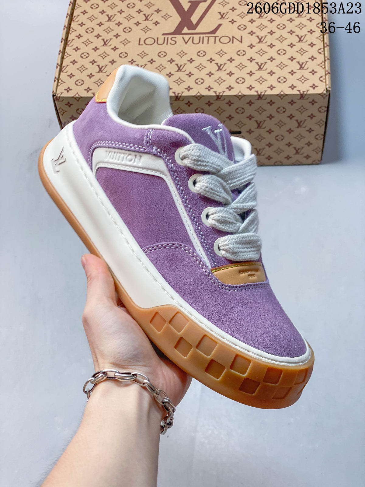 Angled side view highlighting the purple upper, white trim, and gum-colored sole