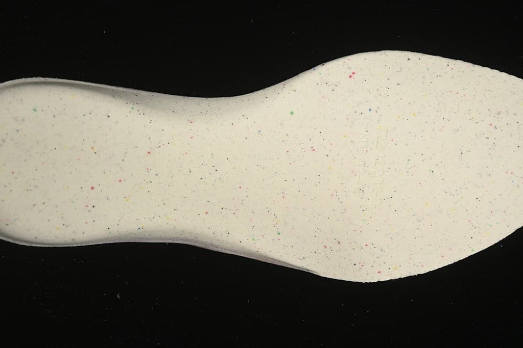 Close-up of the light-colored outsole with multicolor speckles.