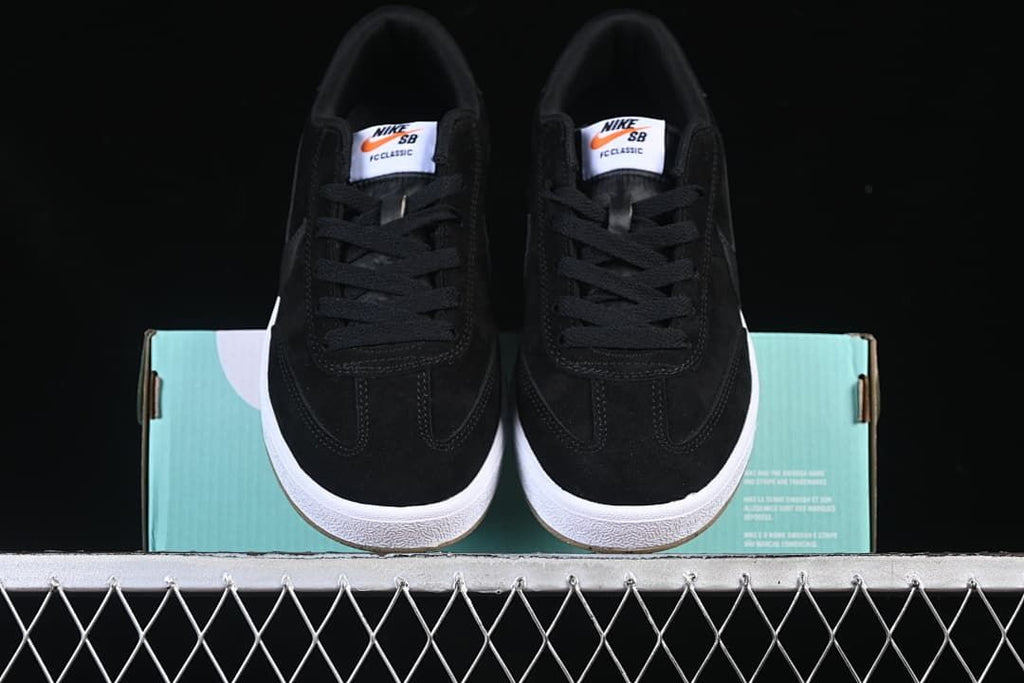 Front view of the pair showing black uppers, branded tongues and white midsoles.