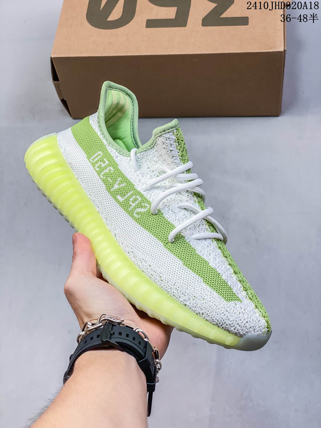 Side view of a green and white Yeezy Boost 350 V2 sneaker