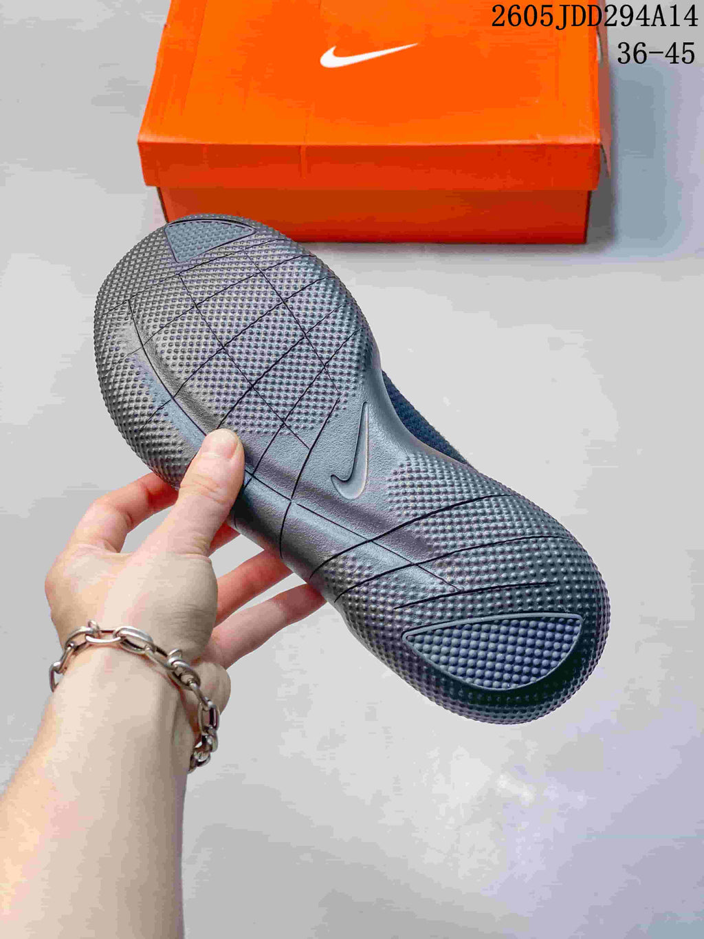 Close-up of the textured, grooved outsole of a dark gray Nike Free shoe