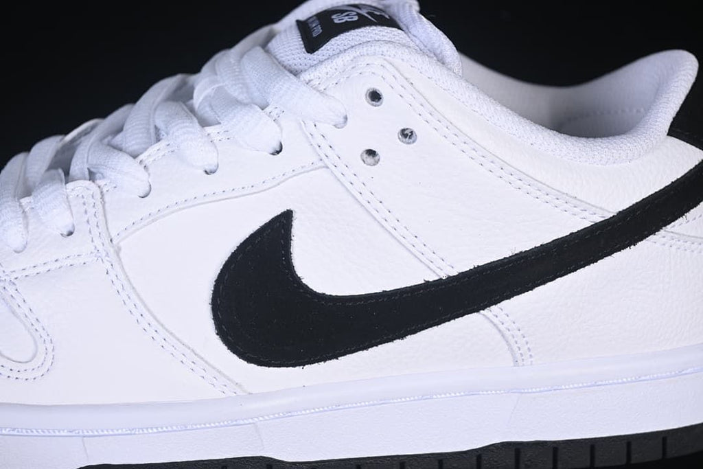 Close-up of the white upper, black Swoosh, and lace eyelets