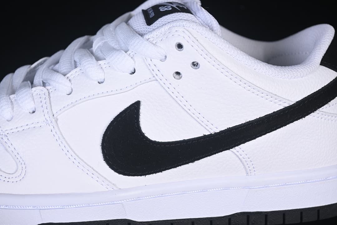 Close-up of the white upper, black Swoosh, and lace eyelets