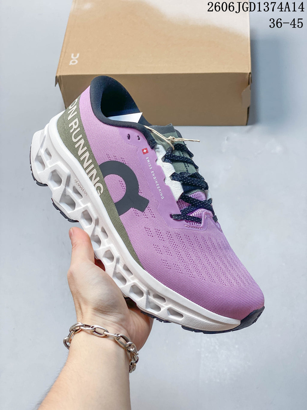 Side view of the lilac shoe showing its olive heel panel, dark branding, and sculpted white sole.