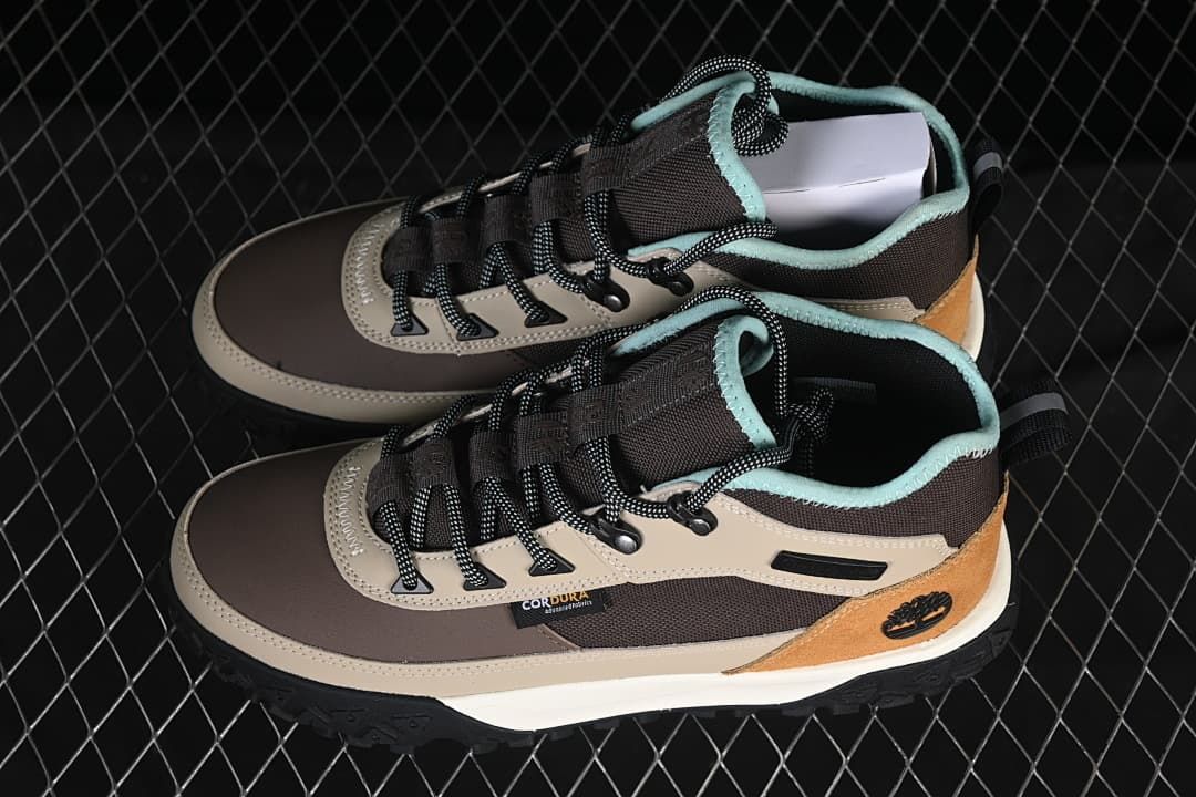 Pair of brown and gray Timberland mid boots shown from above
