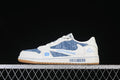 Side view of a low-top sneaker with blue patterned panels, white overlays, blue graphics, and a gum-colored outsole.