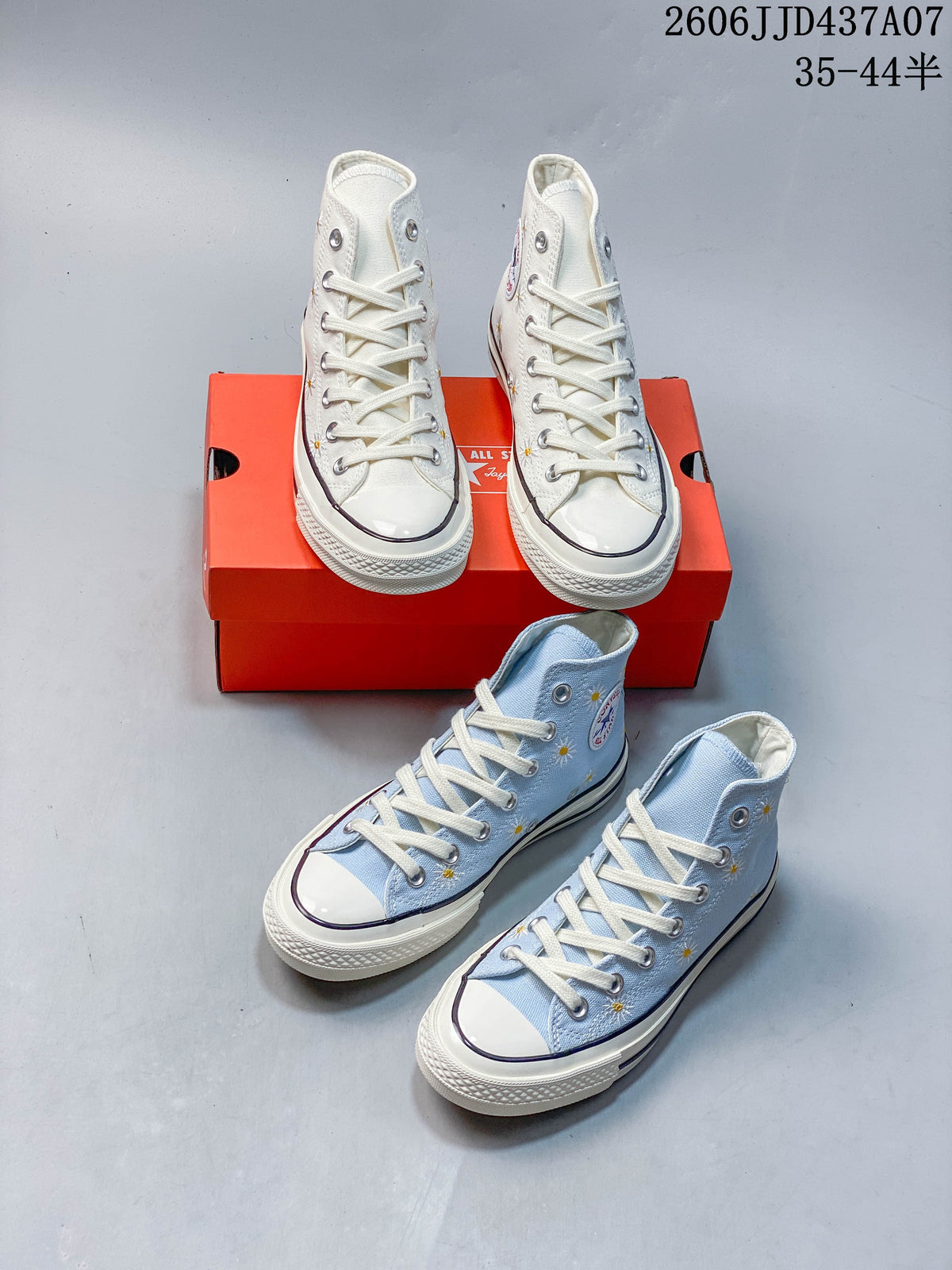 Off-white and light blue daisy-embroidered high-top sneakers shown together