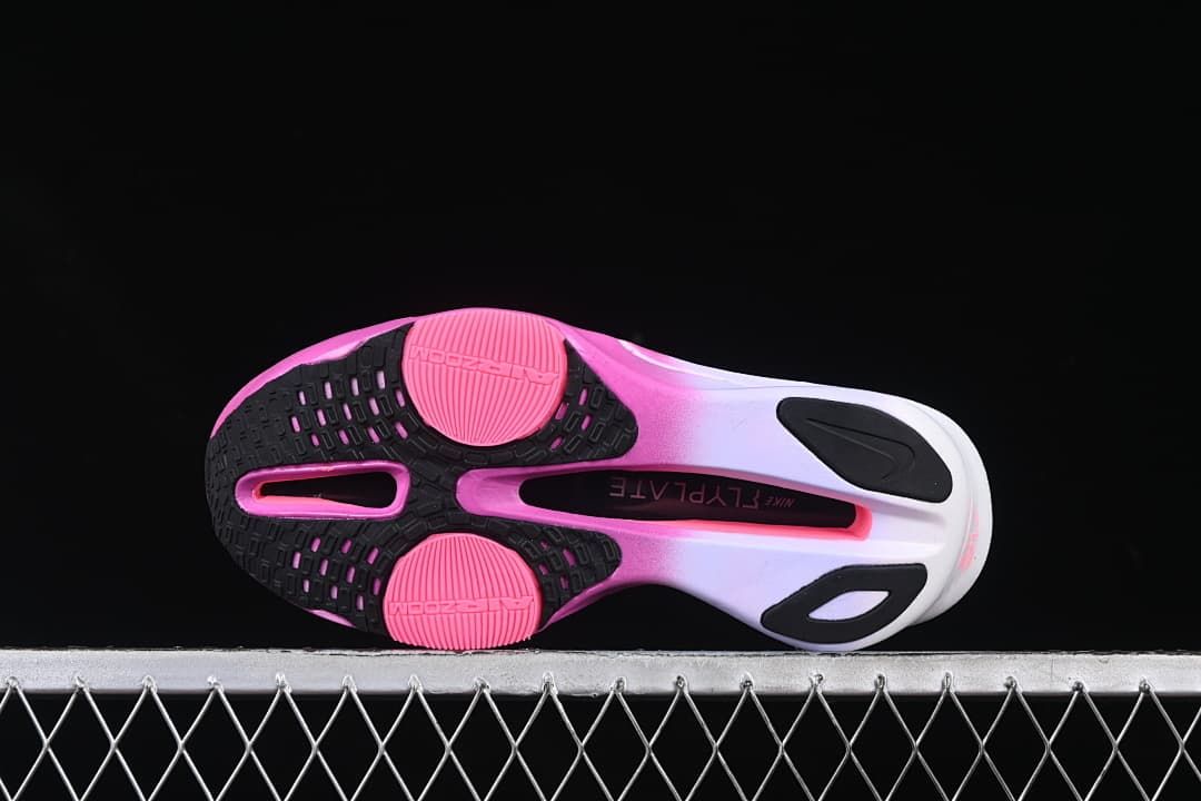 Outsole view showing black and pink traction sections