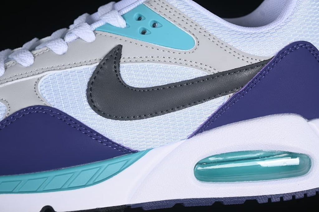 Close-up of the gray and mesh upper, dark Swoosh, purple overlay, and turquoise midsole accent