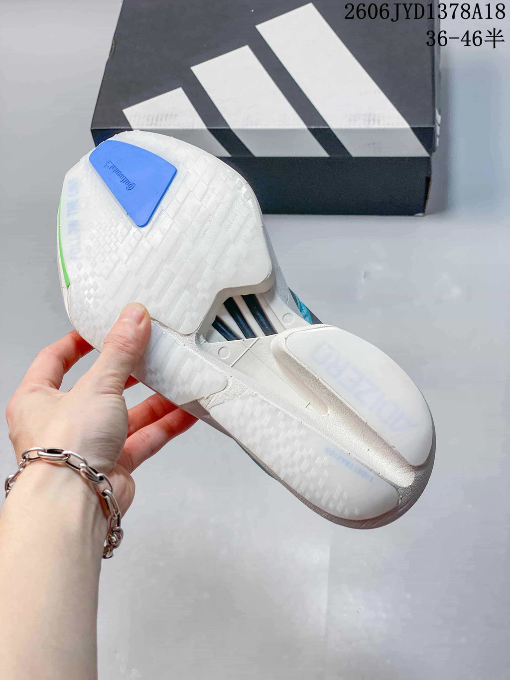 Underside view of the running shoe showing a white outsole and blue heel section