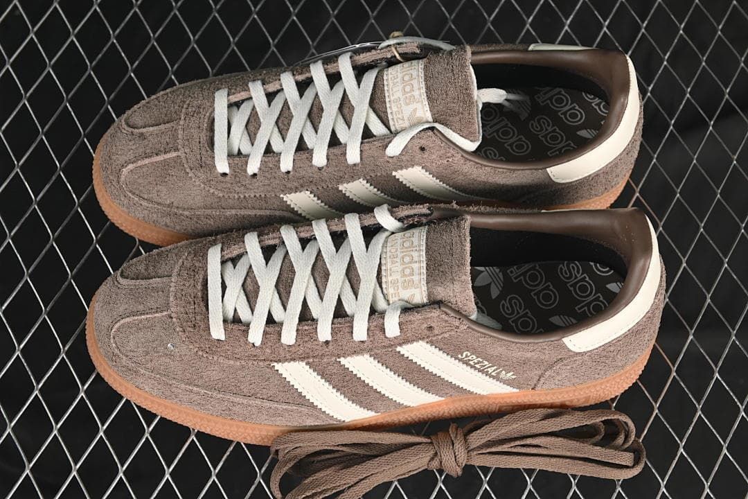 Pair of brown and cream sneakers shown from above with spare brown laces.
