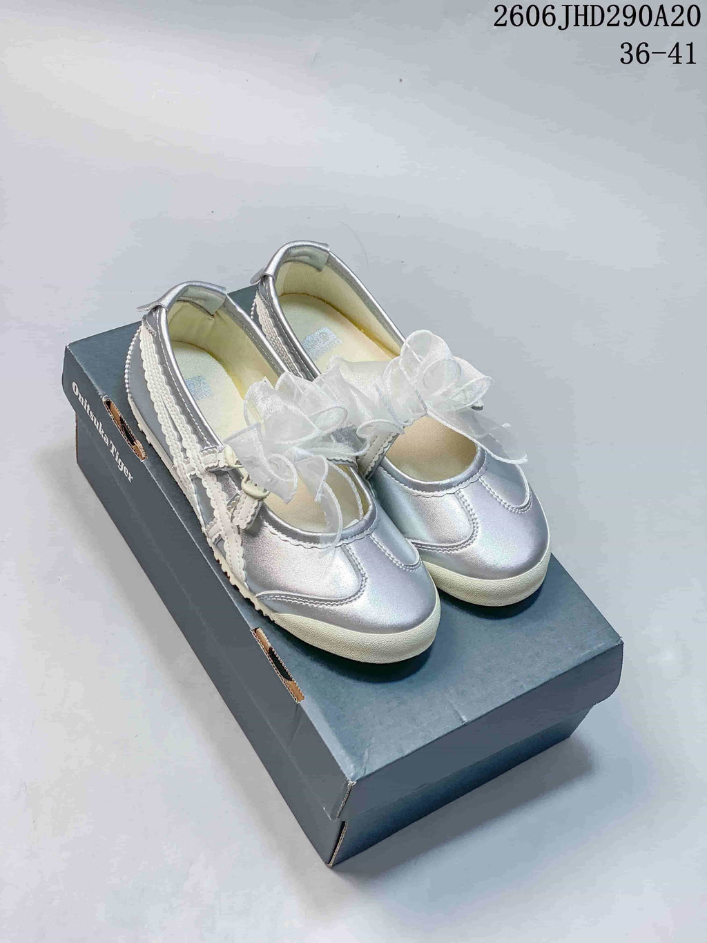 Pair of silver Onitsuka Tiger Mexico 66 TGRS Mary Jane-style shoes with sheer bows and light-colored trim.