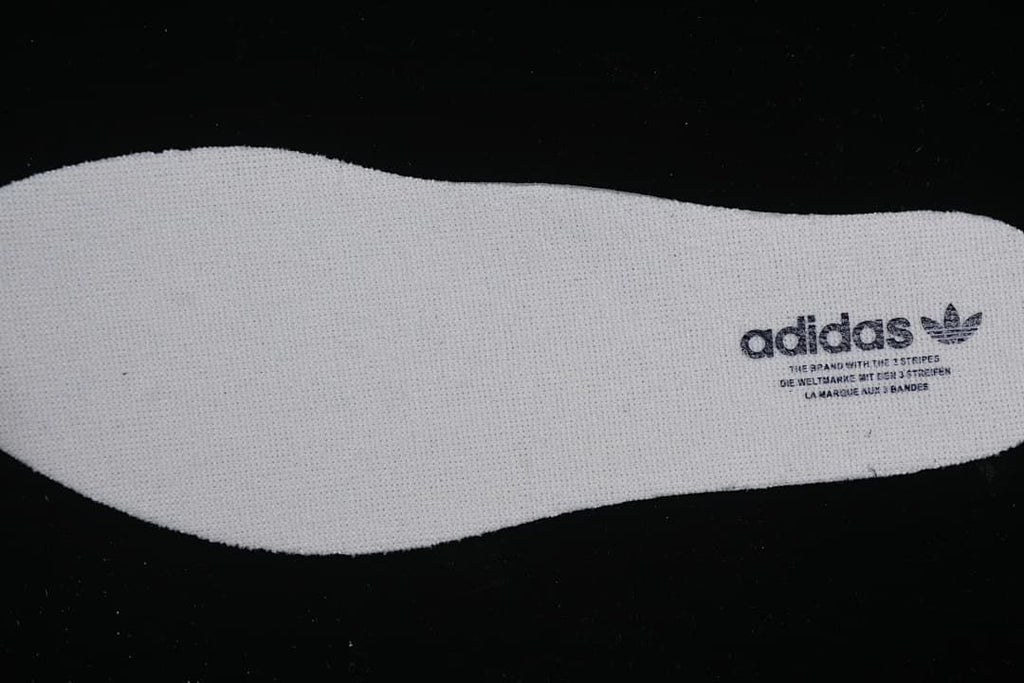 White shoe insole with adidas branding.