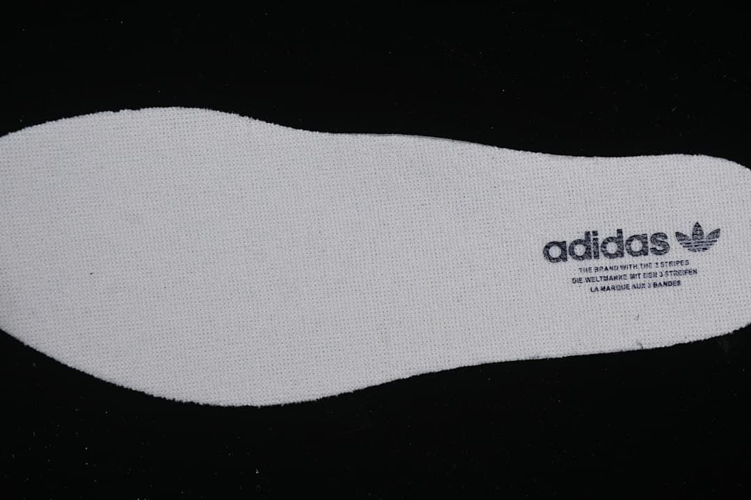 White shoe insole with adidas branding.
