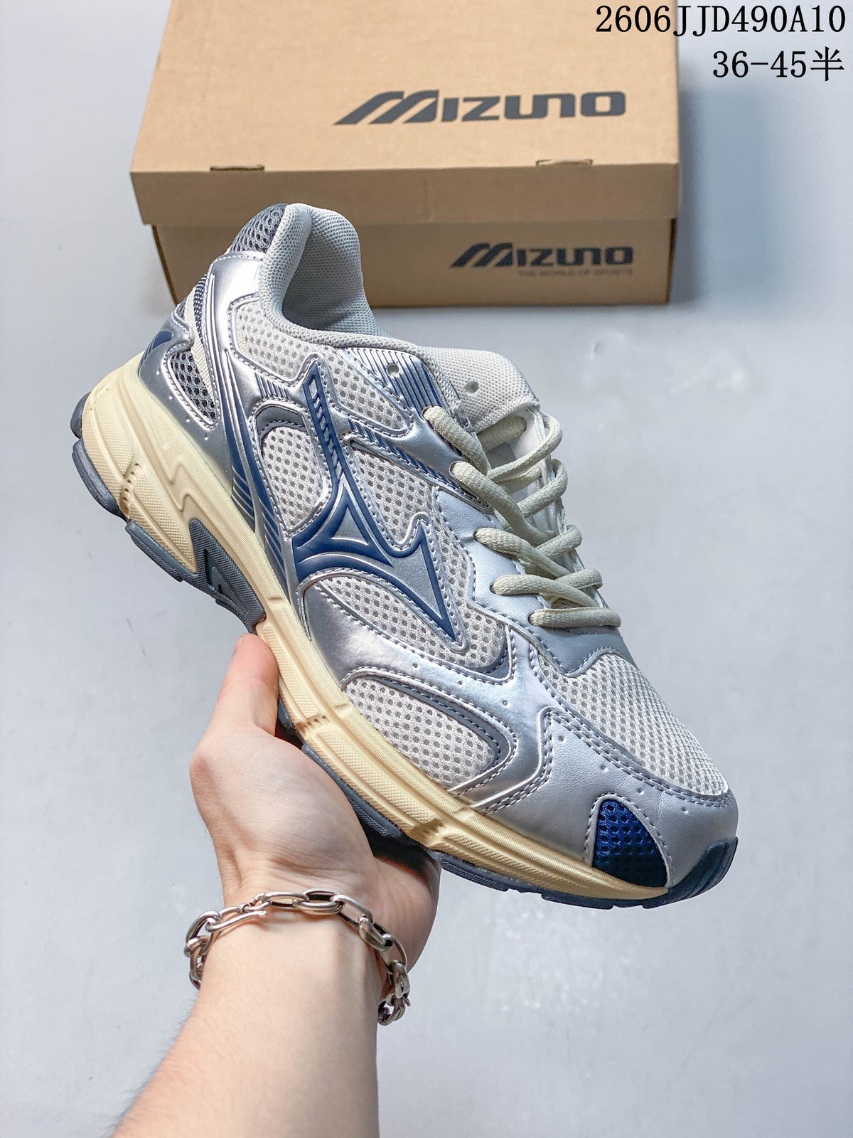 White mesh Mizuno sneaker with dark navy accents and a cream-colored sole.