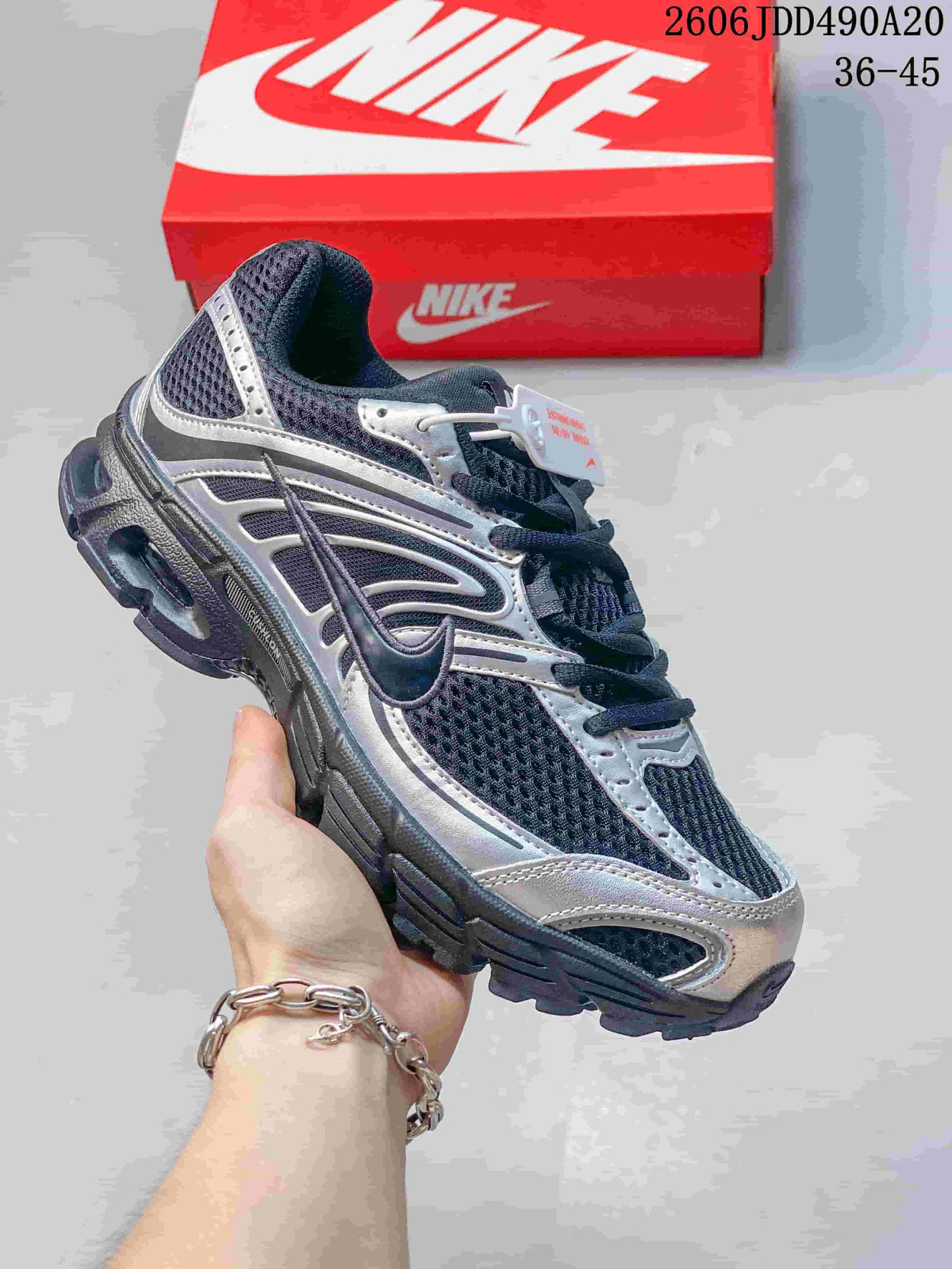 Dark Nike Air Max Moto 2K sneaker with silver overlays