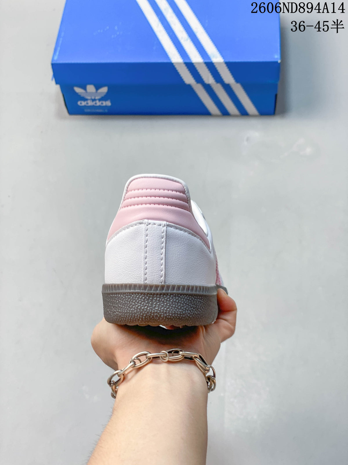 Rear view of an adidas Samba OG sneaker showing its white heel and pink heel detail above the dark outsole.