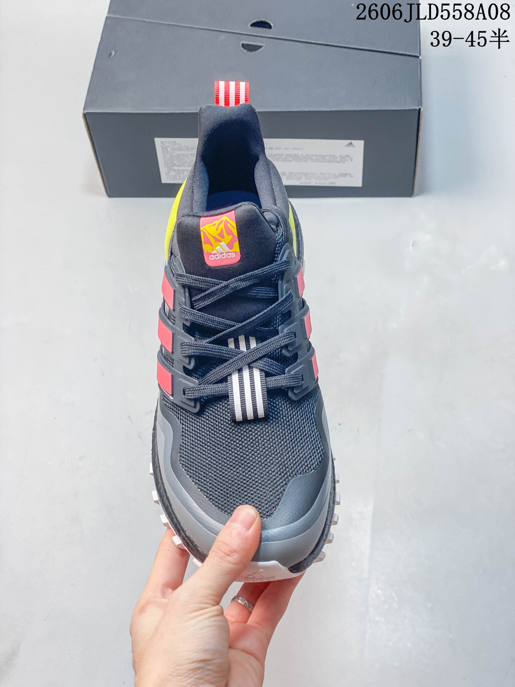 Front view showing the mesh-look toe, laces, and coral-red side stripes