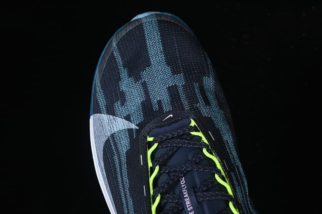 Top view showing the patterned toe, laces and bright yellow-green lace loops.