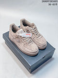 Pair of beige Nike Air Force 1 low-top sneakers on a shoe box