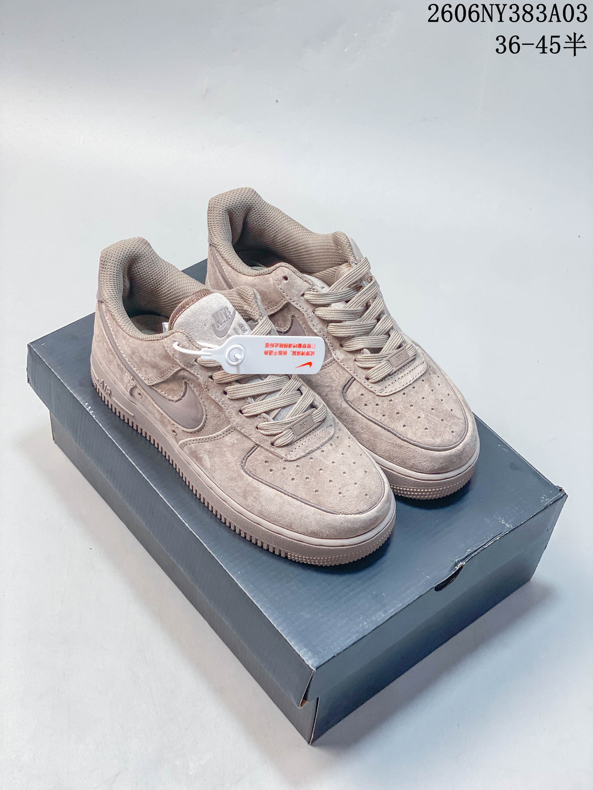 Pair of beige Nike Air Force 1 low-top sneakers on a shoe box