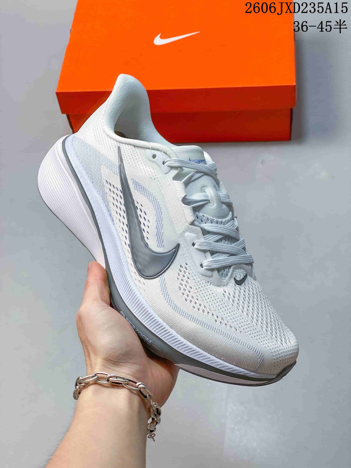 Side profile of the white Nike Pegasus 42 running shoe with grey Swoosh detailing