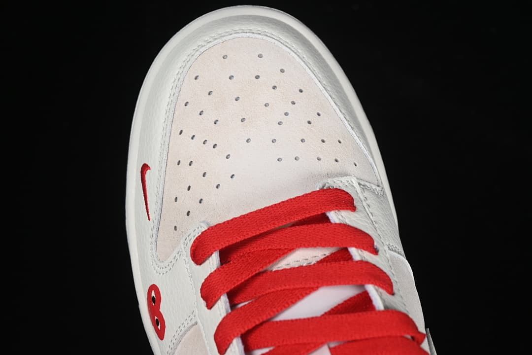 Top view of the perforated toe, red laces, and heart detail