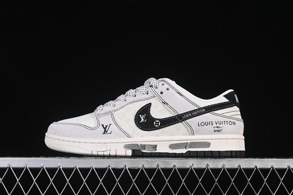 Side profile of white and pale gray low-top sneakers with black side detailing and graphic accents