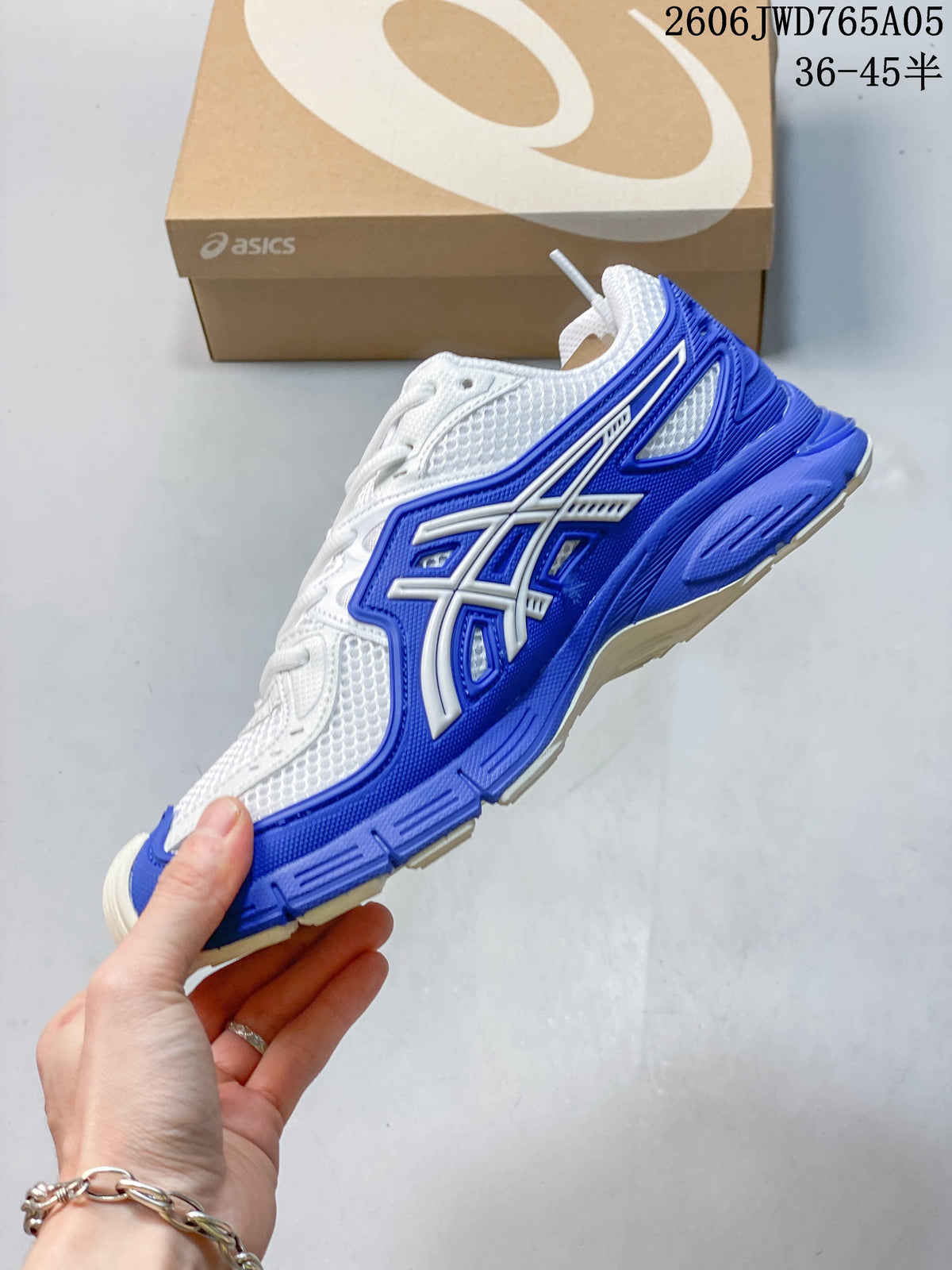 Side view of a white and blue sneaker showing its layered side detailing.
