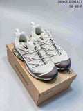 Pair of light-colored Salomon XT-6 Expanse sneakers with dark and green accents, shown on a shoe box.