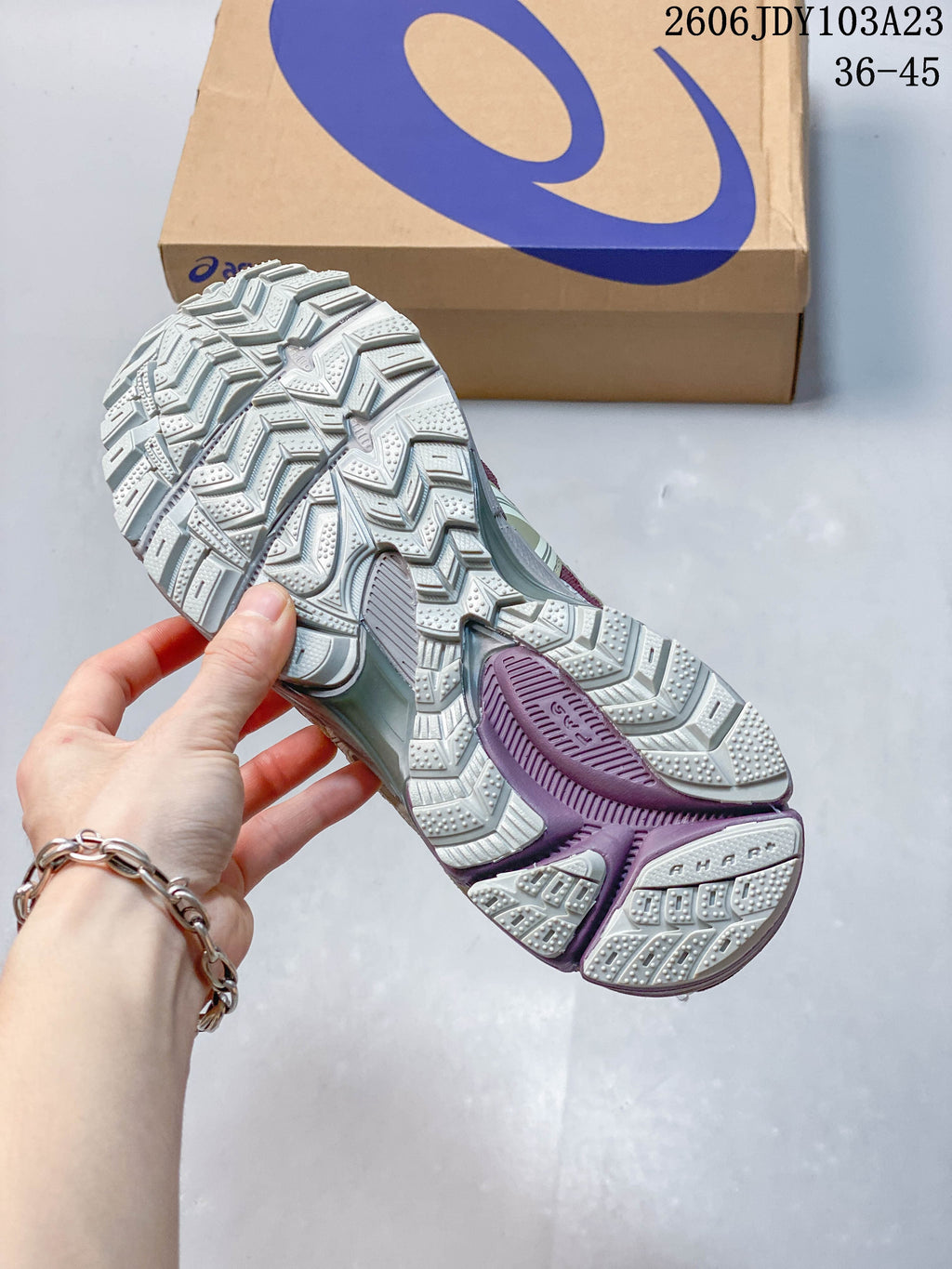 Close-up of the ASICS Gel-Kahana 8 outsole showing its patterned tread and purple accent sections.