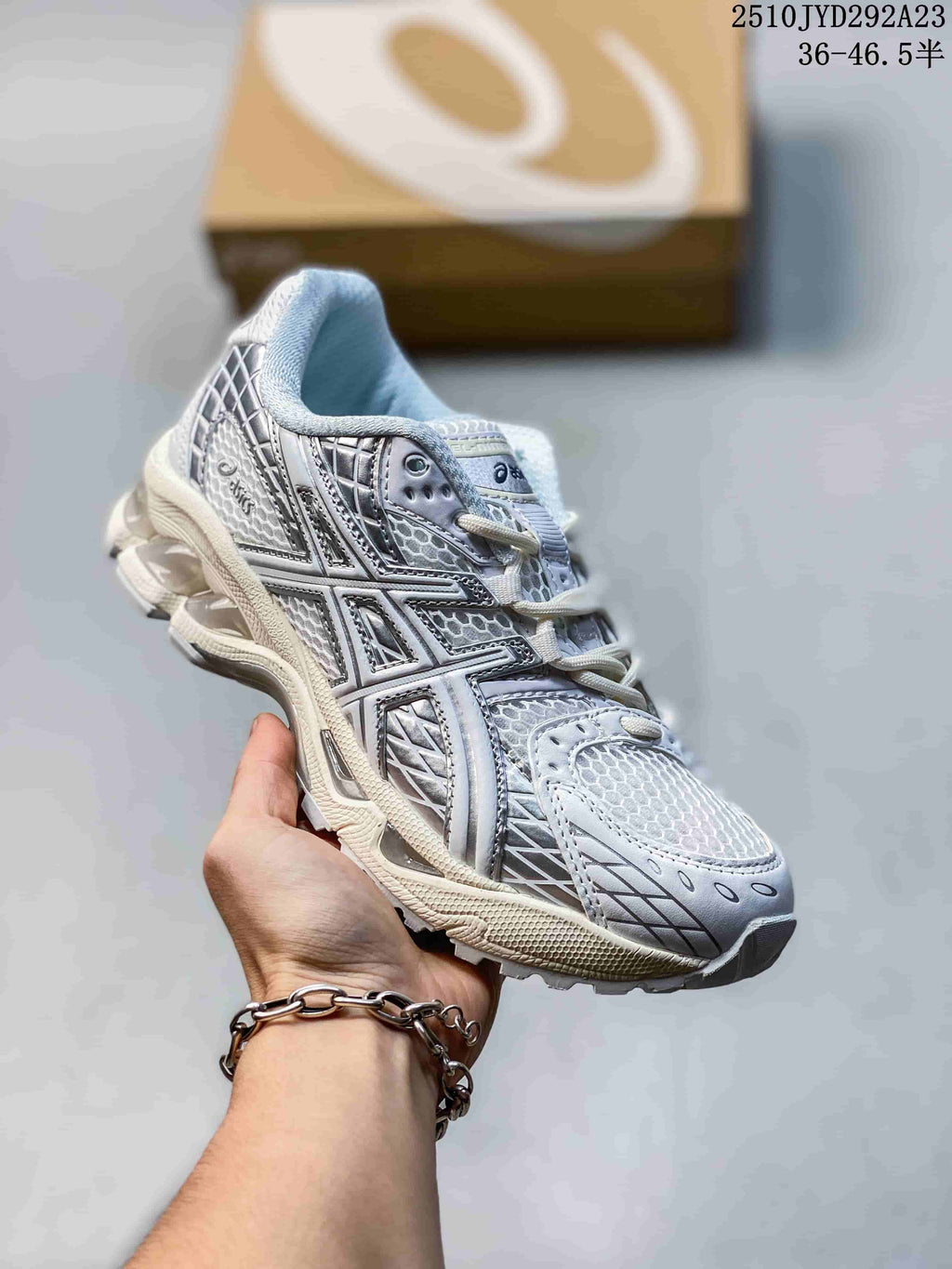 White and silver ASICS Gel-Nimbus sneaker with dark accent detailing.