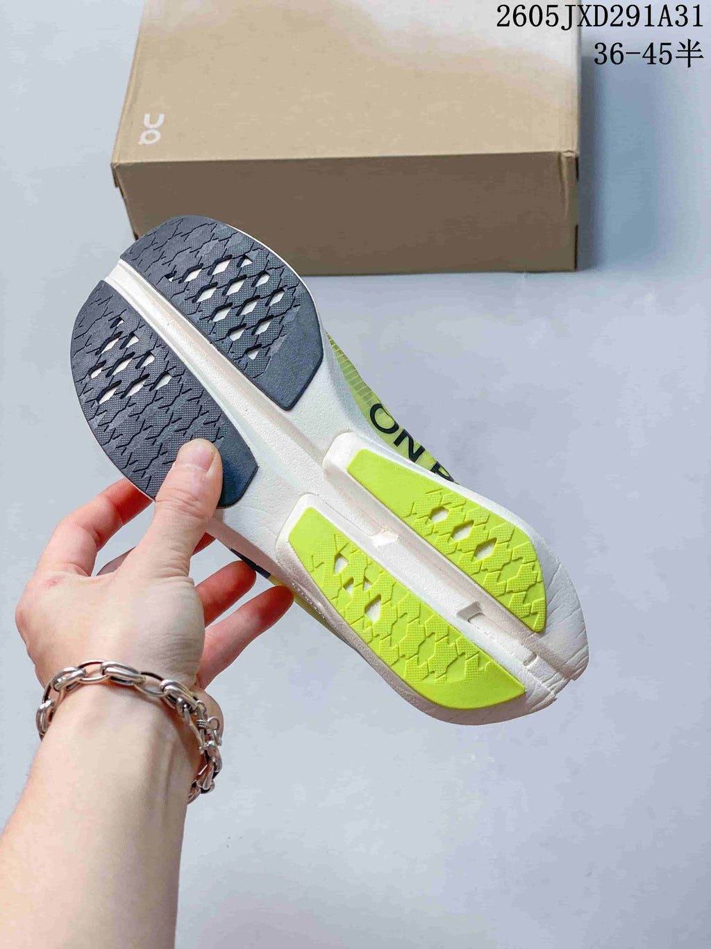 Underside of the running shoe showing the outsole tread and contrasting sections.