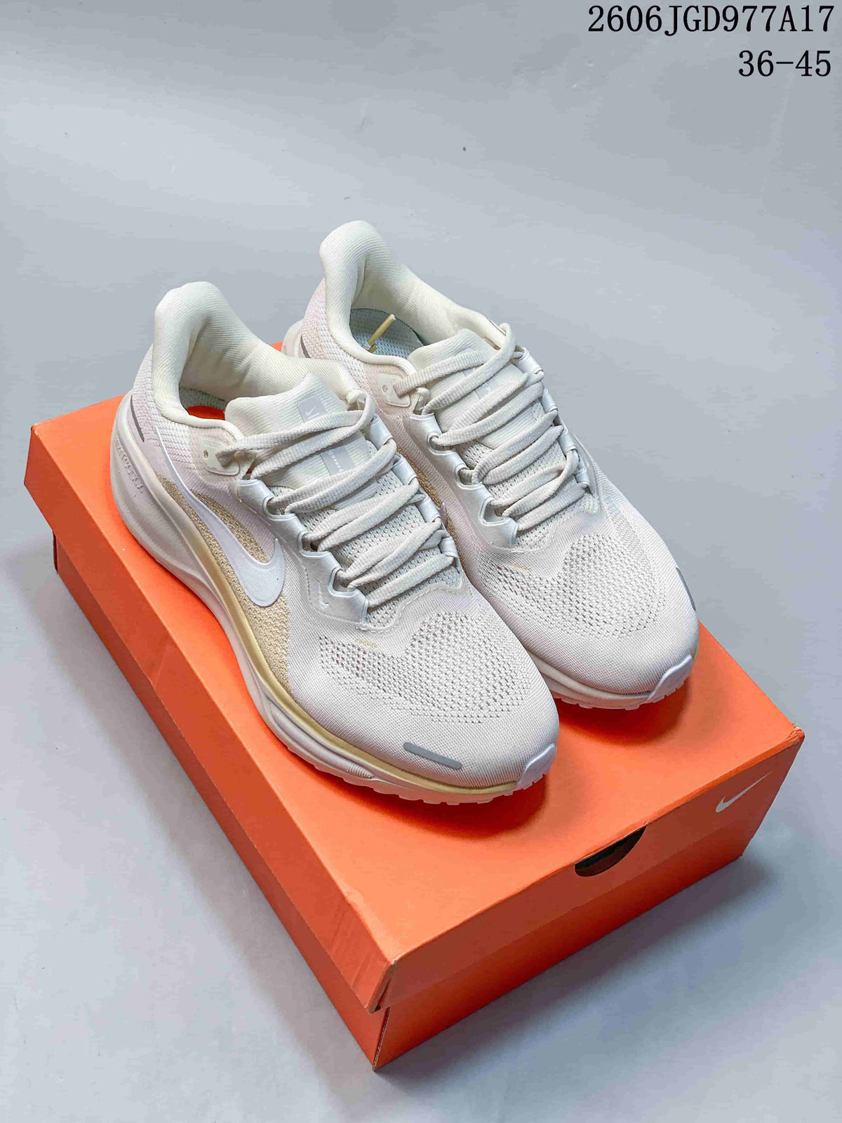 Pair of off-white Nike Air Zoom Pegasus 41 shoes with pale gold side accents, shown from above on an orange box.