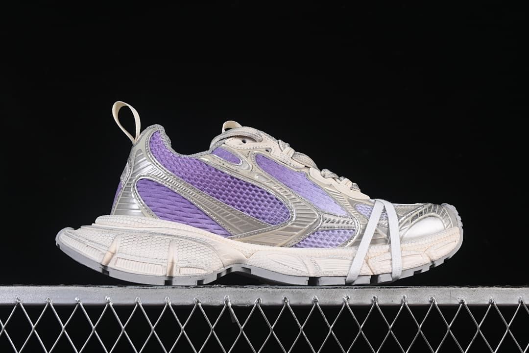 Side profile of the sneaker with lilac panels and sculpted sole.