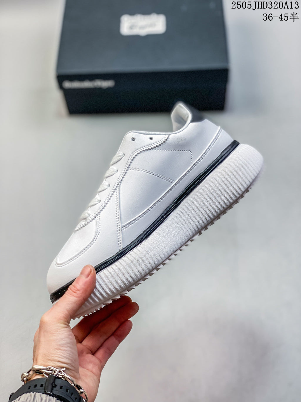 Side profile of the white low-top sneaker with stitched panels and a black sole accent.