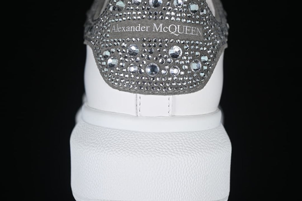 Rear view showing a crystal-embellished heel tab with Alexander McQueen text.