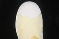 Close-up of the cream woven upper and white textured shell toe.