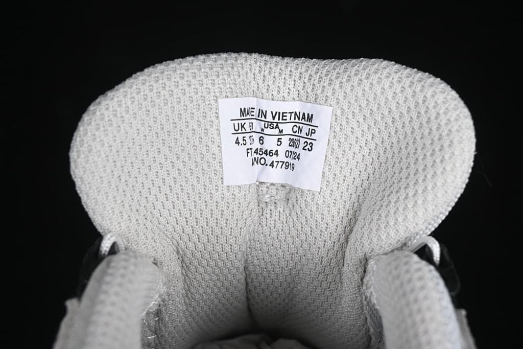 Inside tongue size label showing UK, US, CN and JP sizing for the photographed sample