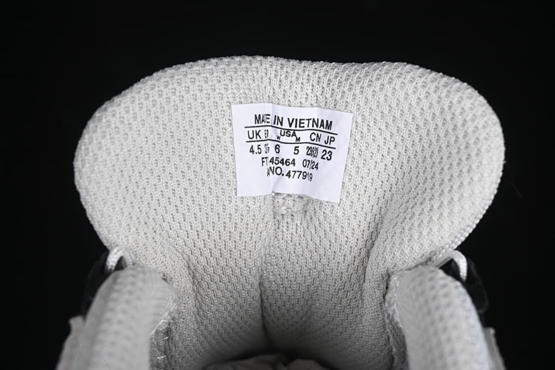 Inside tongue size label showing UK, US, CN and JP sizing for the photographed sample