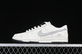 Side view of white Nike Dunk Low sneakers with grey Swoosh panels, black laces and Stüssy script detailing.