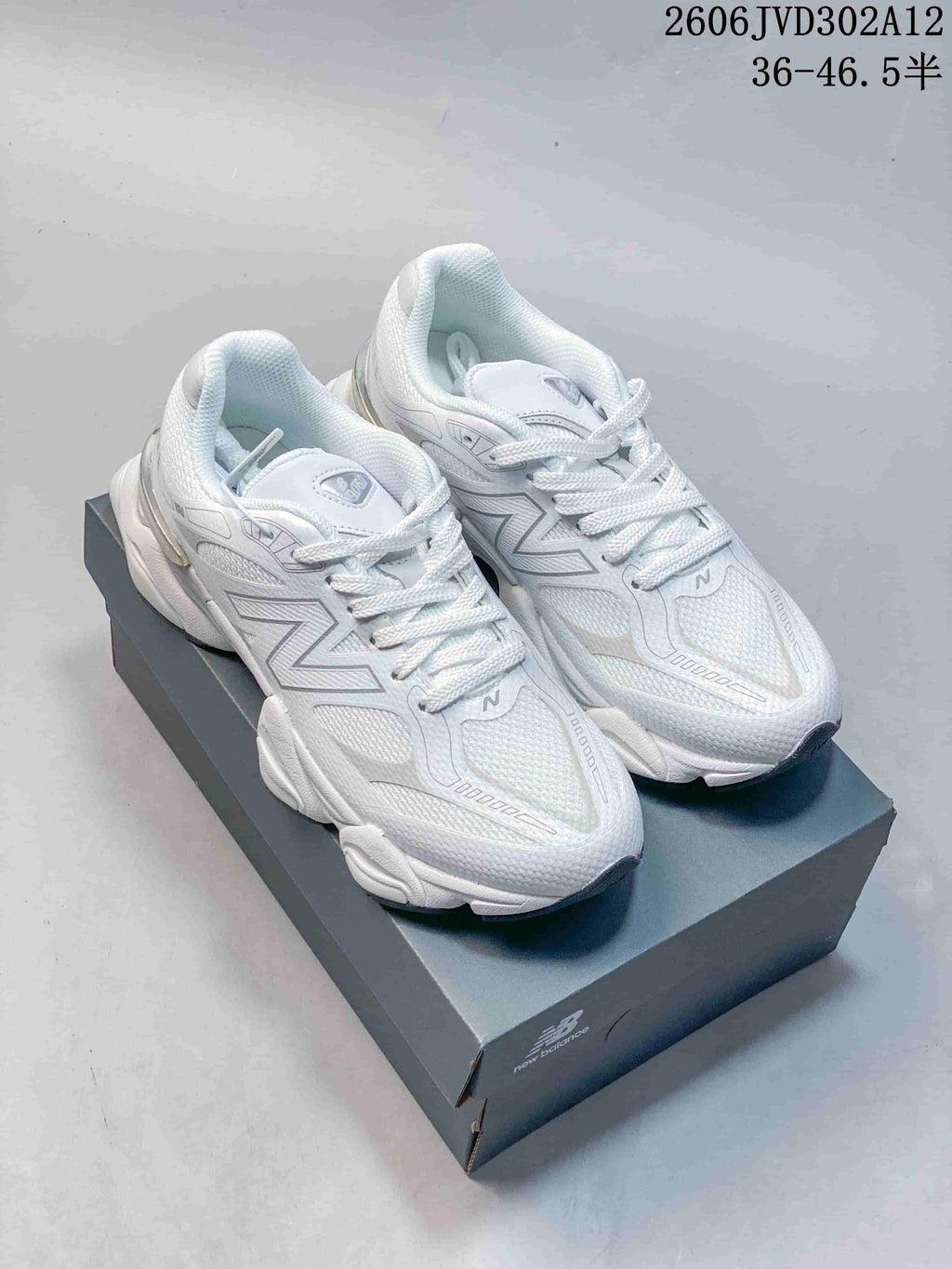 Pair of white New Balance 9060 sneakers shown from above and at an angle.