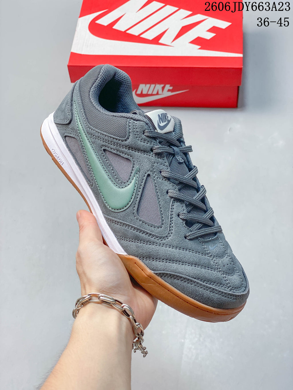 Close-up of a gray Nike Gato sneaker with pale green side accent and gum-colored sole